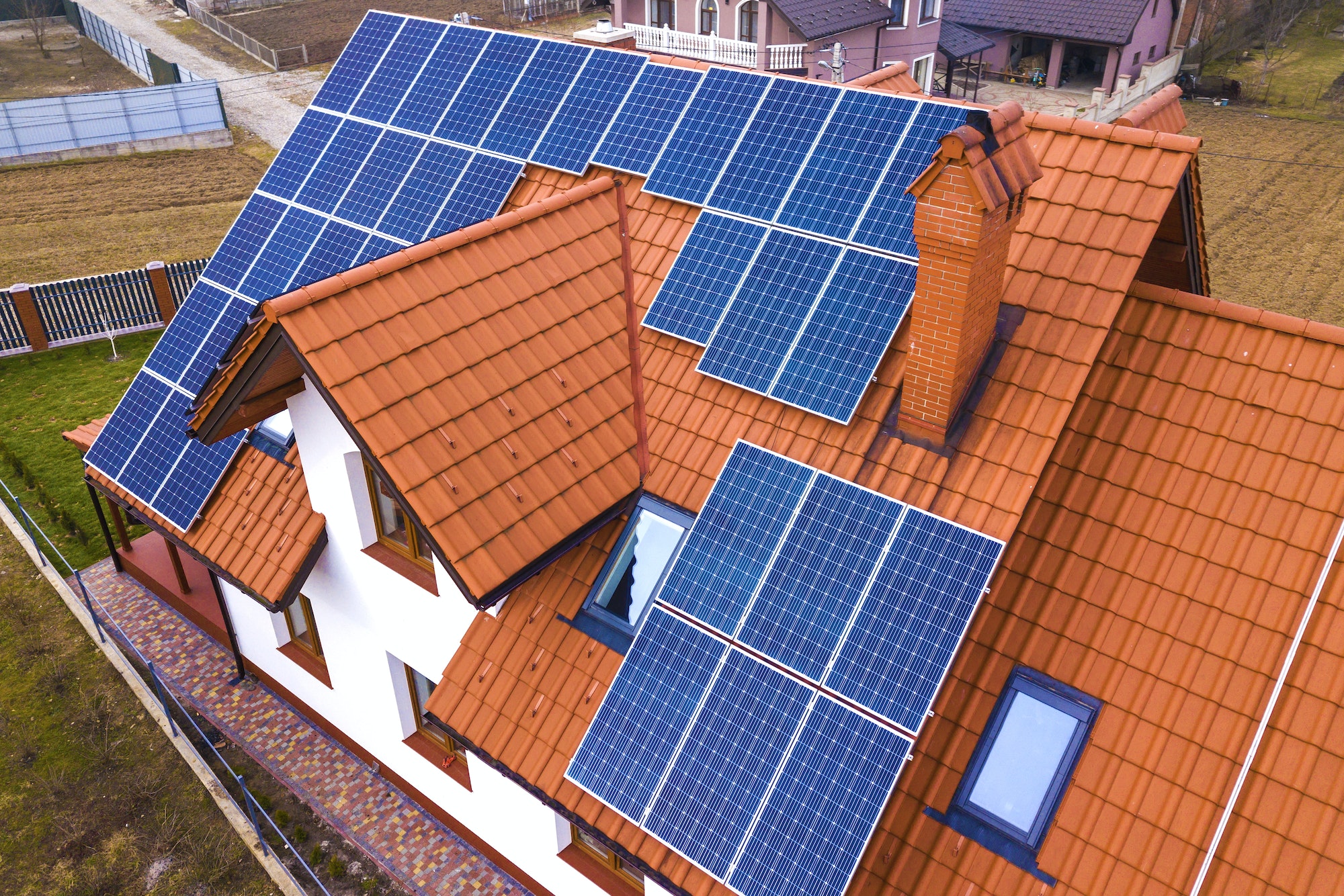 aerial-top-view-of-new-modern-residential-house-cottage-with-blue-shiny-solar-photo-voltaic-panels.jpg